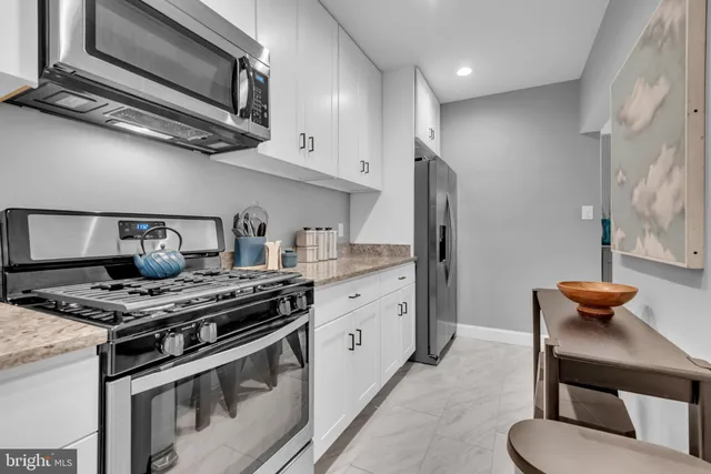 a bedroom with a bed and a couch next to a window