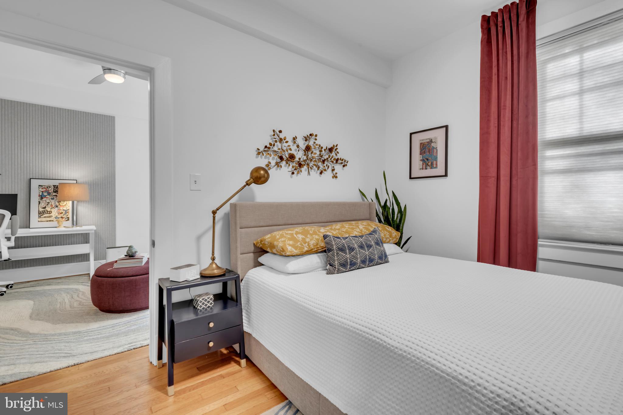 3020 Porter Street Northwest, Unit 103 Washington, DC 20008 - Photo 20 of 30 a bedroom with a bed and a chandelier