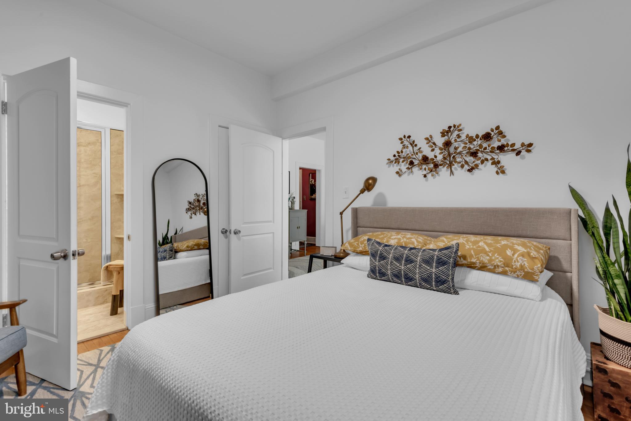 3020 Porter Street Northwest, Unit 103 Washington, DC 20008 - Photo 21 of 30 a bedroom with a bed and a painting on the wall