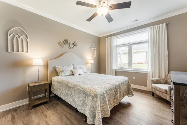a bedroom with a bed and a chandelier