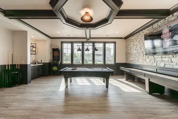 a view of a room with wooden floor and furniture