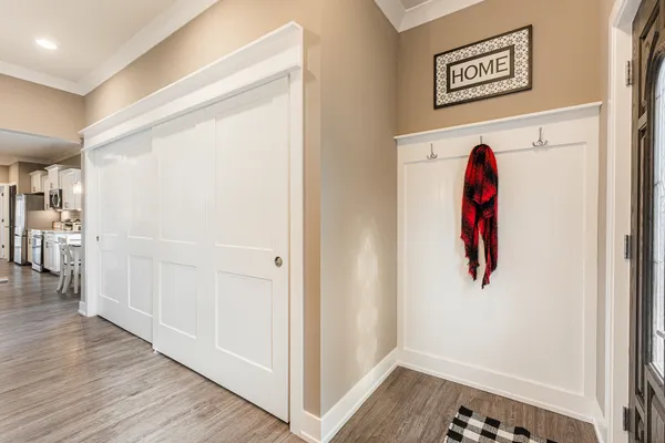 a view of a hallway with wooden floor and entryway