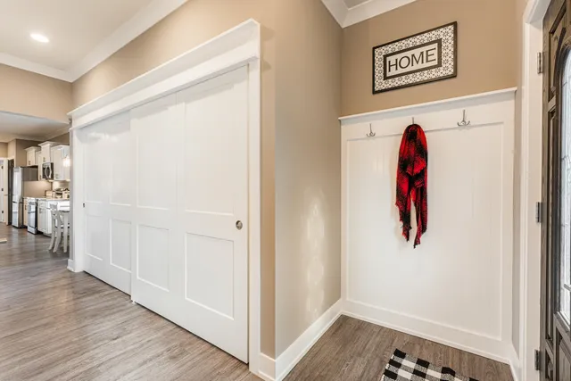 a view of a hallway with wooden floor and entryway
