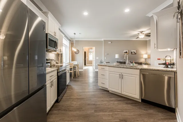 a large kitchen with stainless steel appliances and a refrigerator