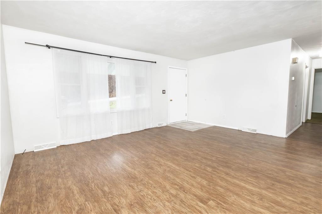 246 King Hill Road Indiana, PA 15701 - Photo 9 of 24 a view of a big room with wooden floor and a refrigerator