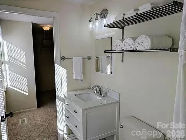 a bathroom with a sink vanity and a mirror