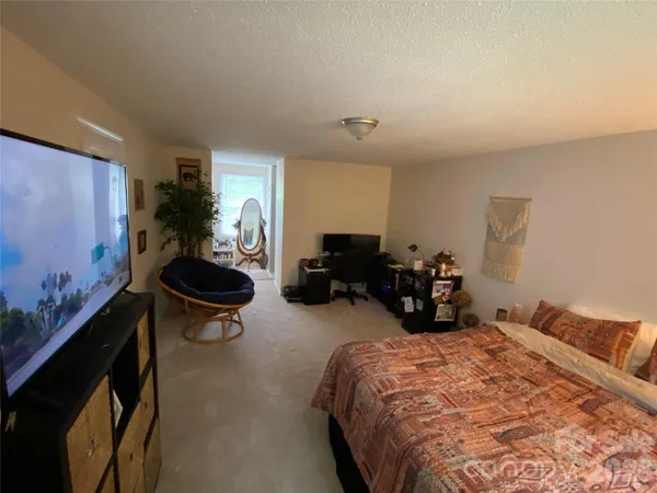a bed room with a bed and a chair