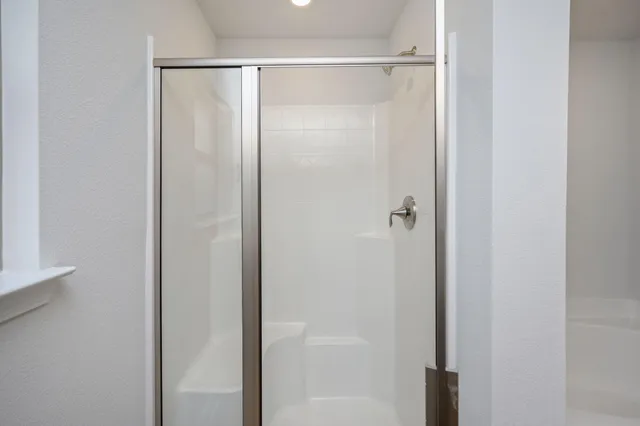 a bathroom with a glass shower door
