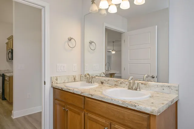 a bathroom with a granite countertop sink and a mirror