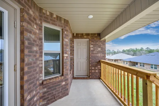 a view of a balcony next to a yard