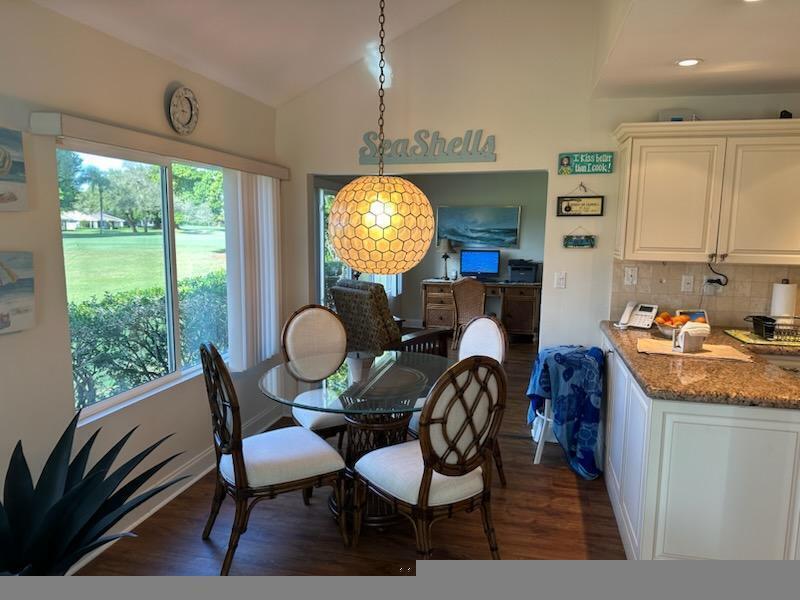 17042 Traverse Circle Jupiter, FL 33477 - Photo 11 of 30 a dining room with furniture a window and a chandelier