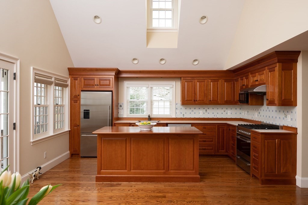 40 Spring Street Hingham, MA 02043 - Photo 12 of 27 a kitchen with stainless steel appliances granite countertop a sink stove and refrigerator