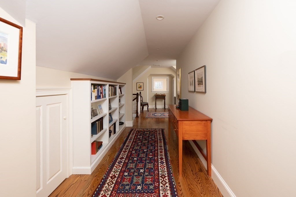 40 Spring Street Hingham, MA 02043 - Photo 18 of 27 a hallway with white cabinets and wooden floor