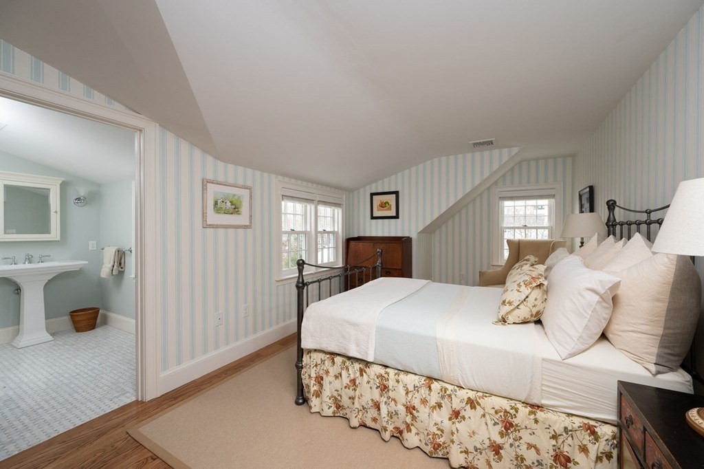 40 Spring Street Hingham, MA 02043 - Photo 19 of 27 a bedroom with a large bed and a window