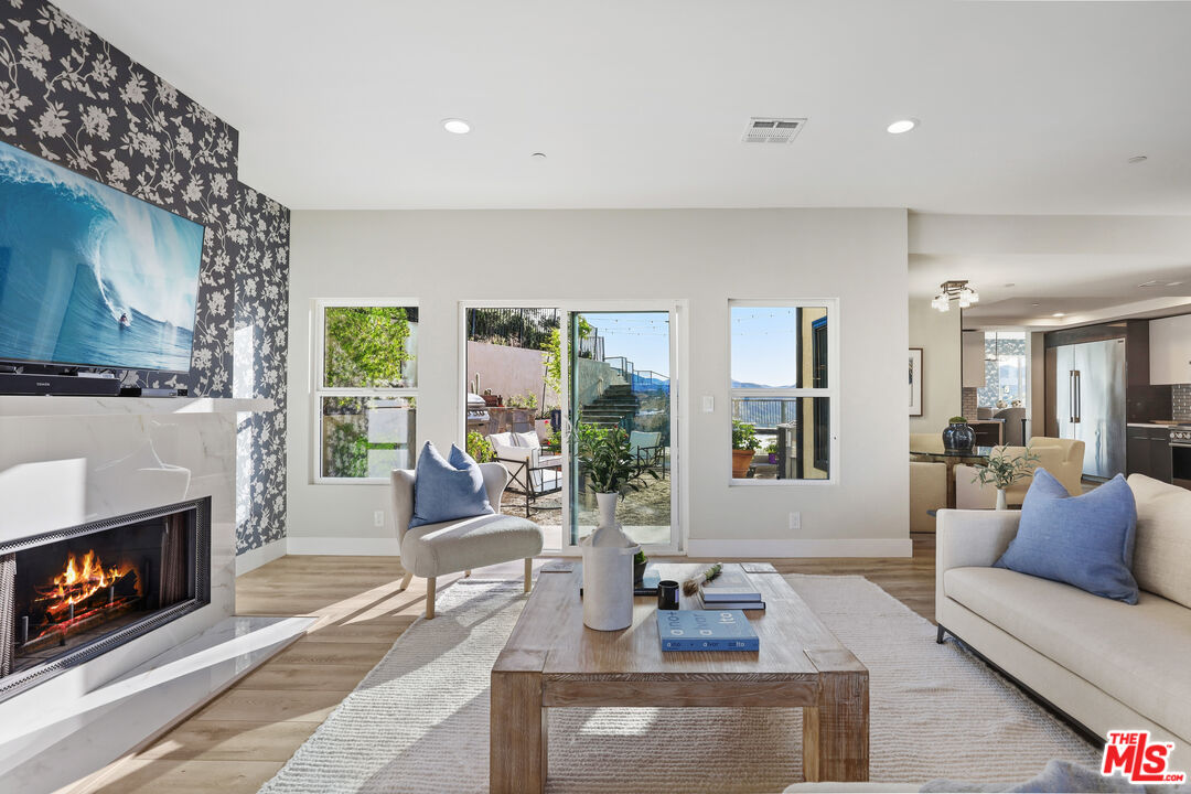 53 Saddlebow Road Bell Canyon, CA 91307 - Photo 21 of 66 a living room with furniture a large window and a fireplace