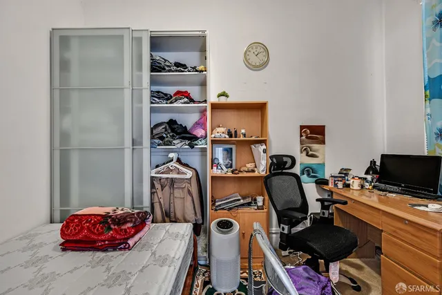 a view of a workspace with furniture and closet