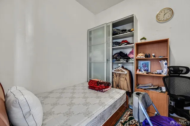 a view of a hallway with wooden floor and windows