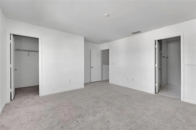 a kitchen with white cabinets a sink and white appliances