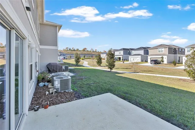 a view of a house with a yard and sitting area