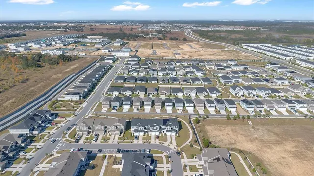 an aerial view of residential houses with outdoor space