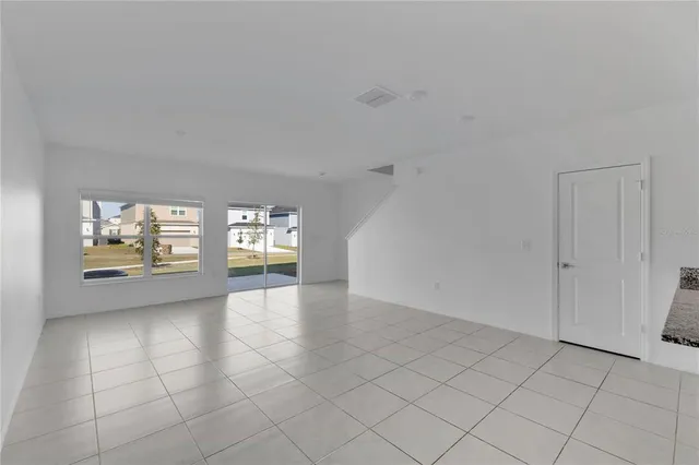 an empty room with windows and entrance