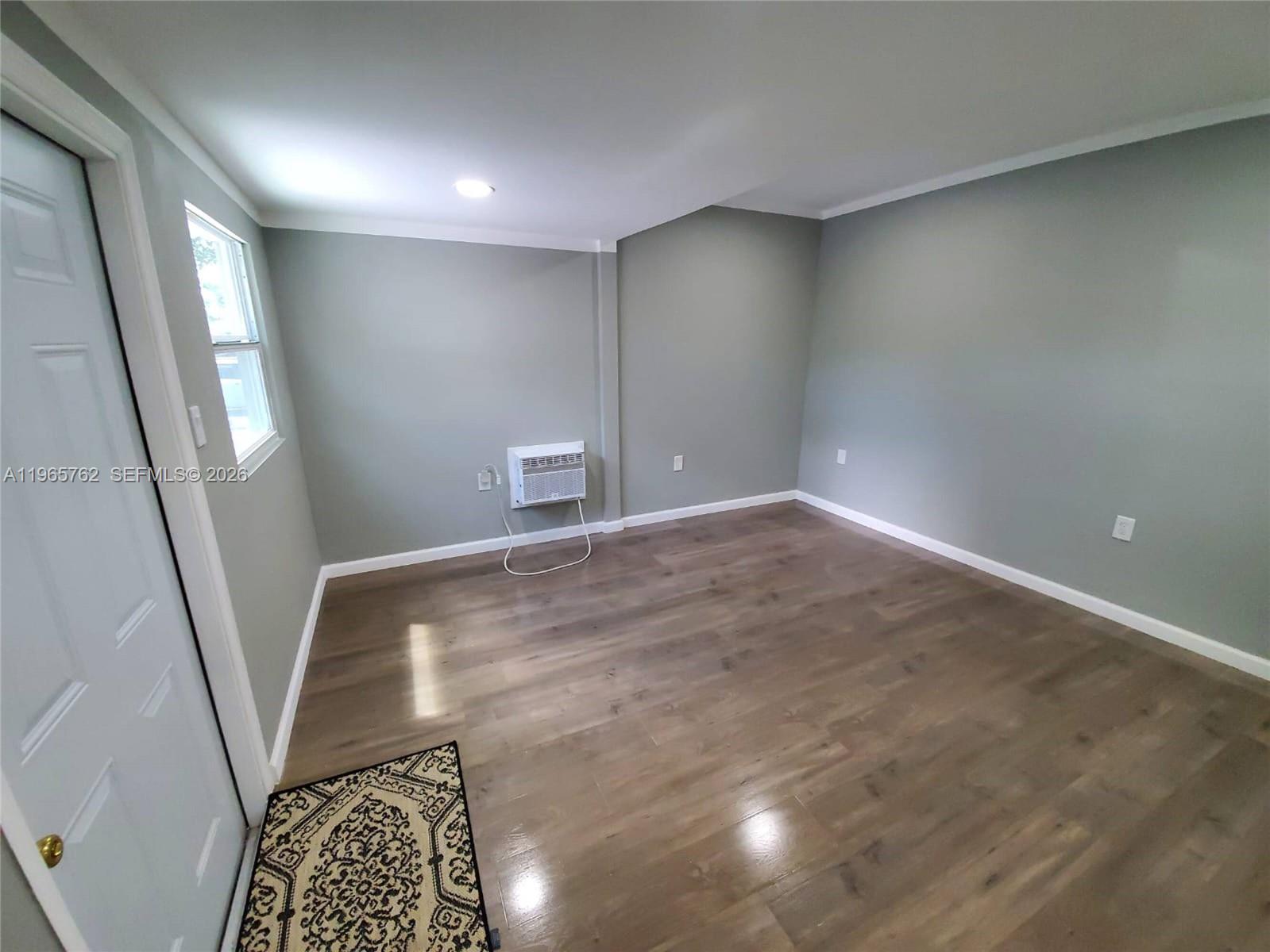 2425 Northwest 28th Street Miami, FL 33142 - Photo 4 of 18 an empty room with windows