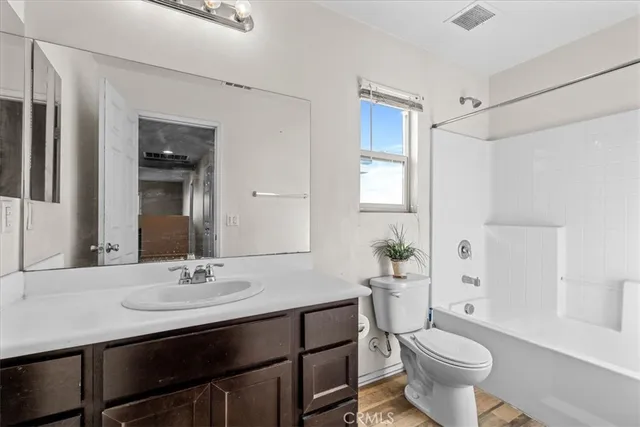 a spacious bathroom with a double vanity sink a large mirror and shower