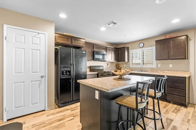 a kitchen with a sink stove top oven and microwave