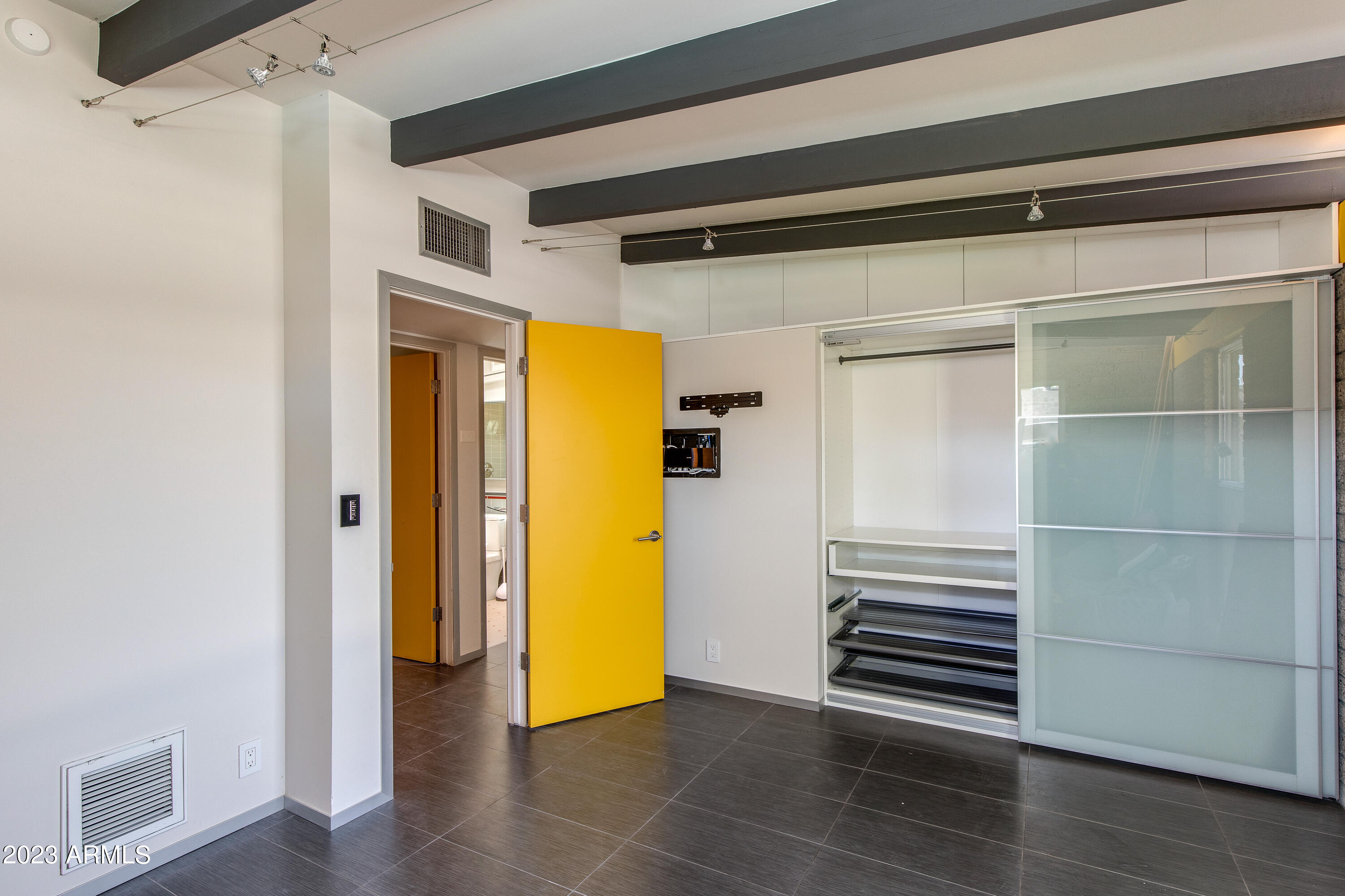 5719 North 11th Street Phoenix, AZ 85014 - Photo 13 of 18 a view of a room with wooden door
