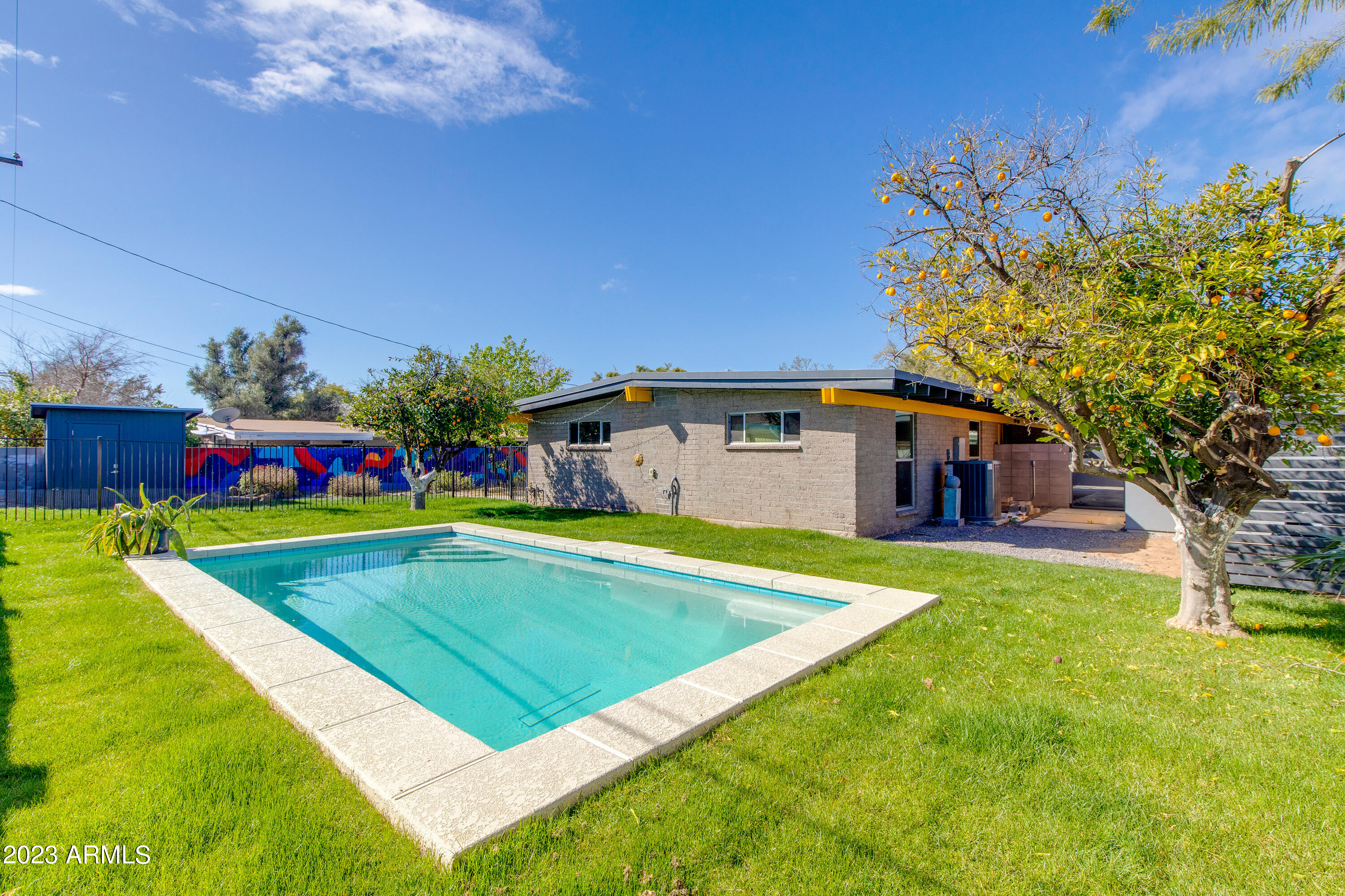 5719 North 11th Street Phoenix, AZ 85014 - Photo 16 of 18 a swimming pool with outdoor seating and yard
