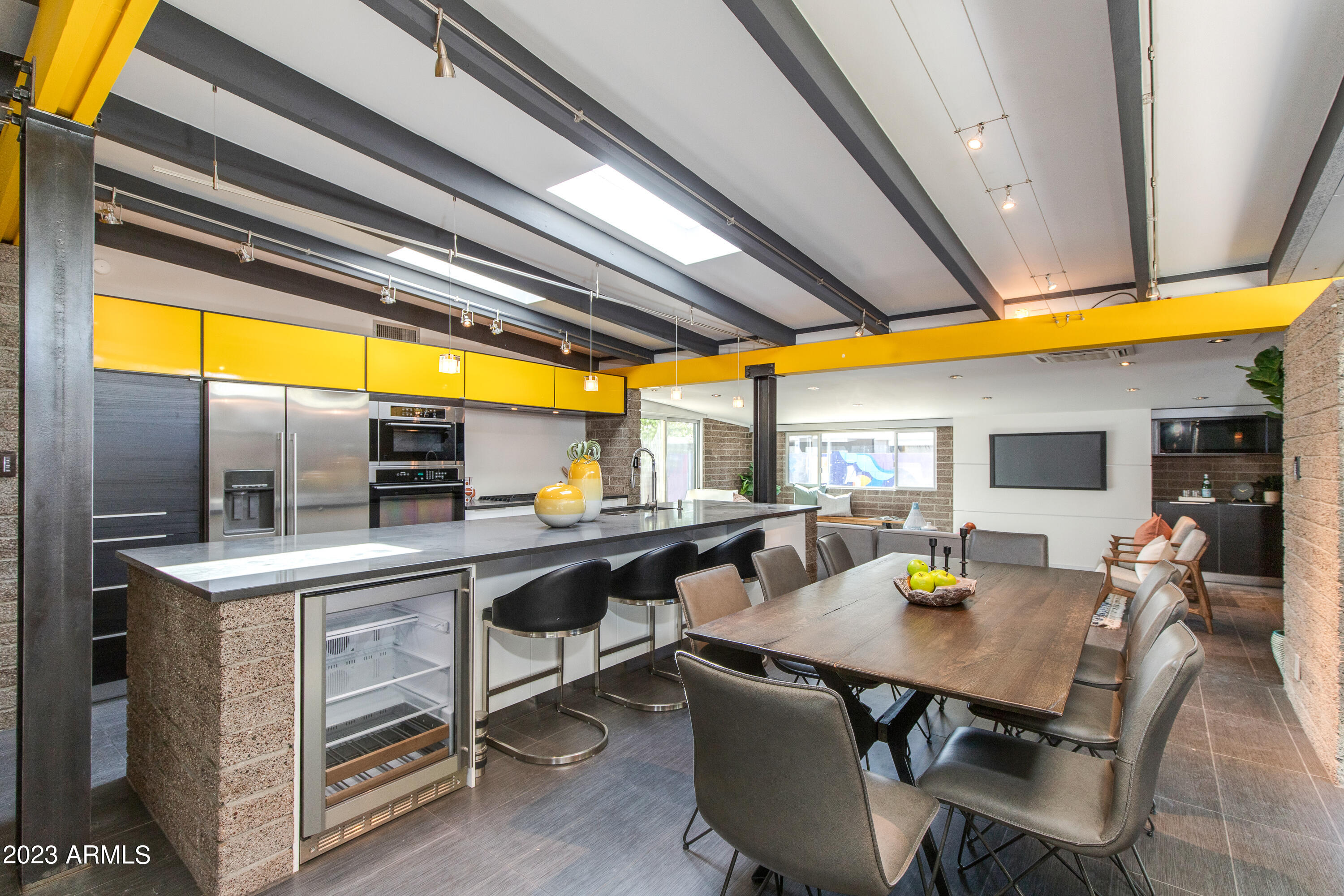 5719 North 11th Street Phoenix, AZ 85014 - Photo 5 of 18 a kitchen with a table chairs and wooden floor