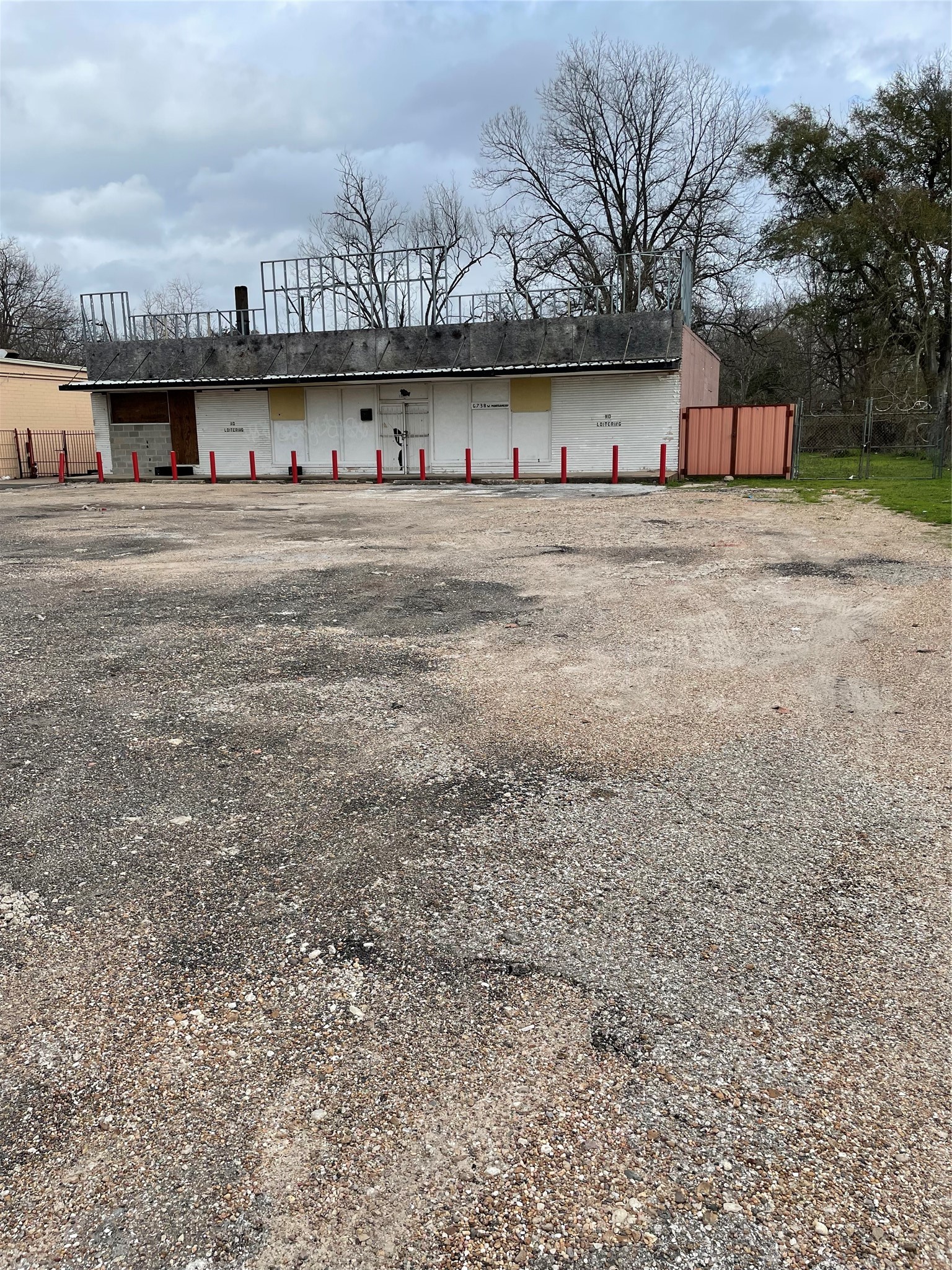 6726 West Montgomery Road Houston, TX 77091 - Photo 3 of 3 a front view of a building with large trees