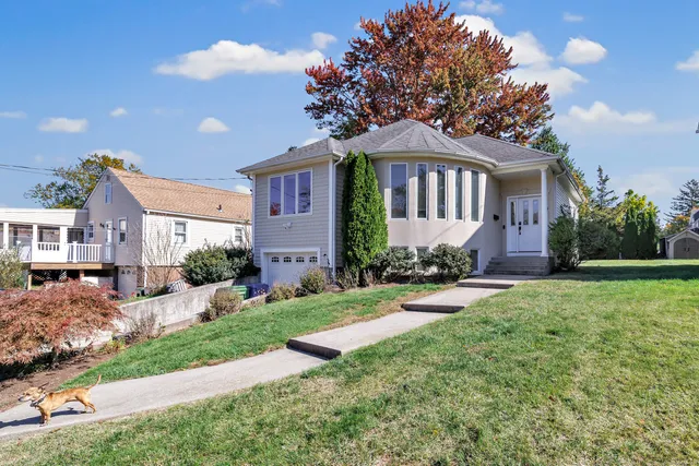 a front view of a house with garden