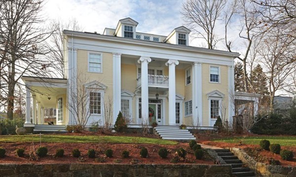 15 Kennard Road Brookline, MA 02445 - Photo 1 of 13 a view of a white house with large windows next to a yard and large trees