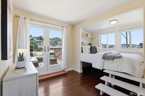 a bedroom with a large bed and a window