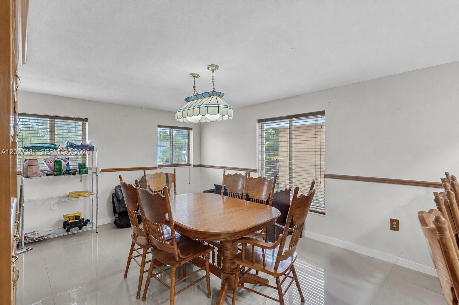 15440 Southwest 294th Terrace Homestead, FL 33033 - Photo 5 of 31 a view of a dining room with furniture and a chandelier