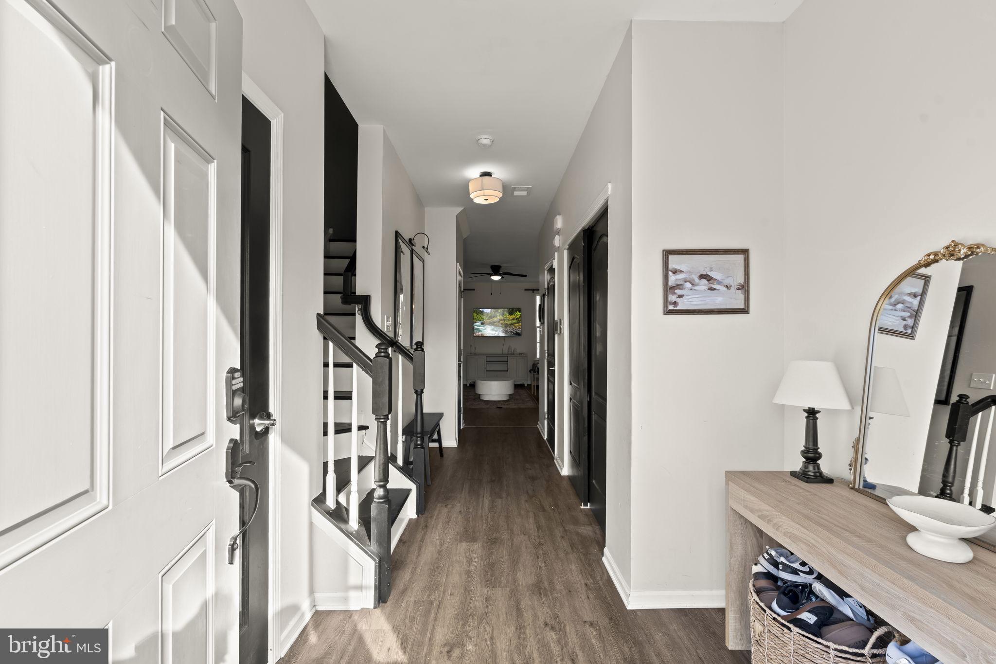103 Oak Ridge Drive Mount Royal, NJ 08061 - Photo 2 of 34 a view of a hallway with furniture and wooden floor