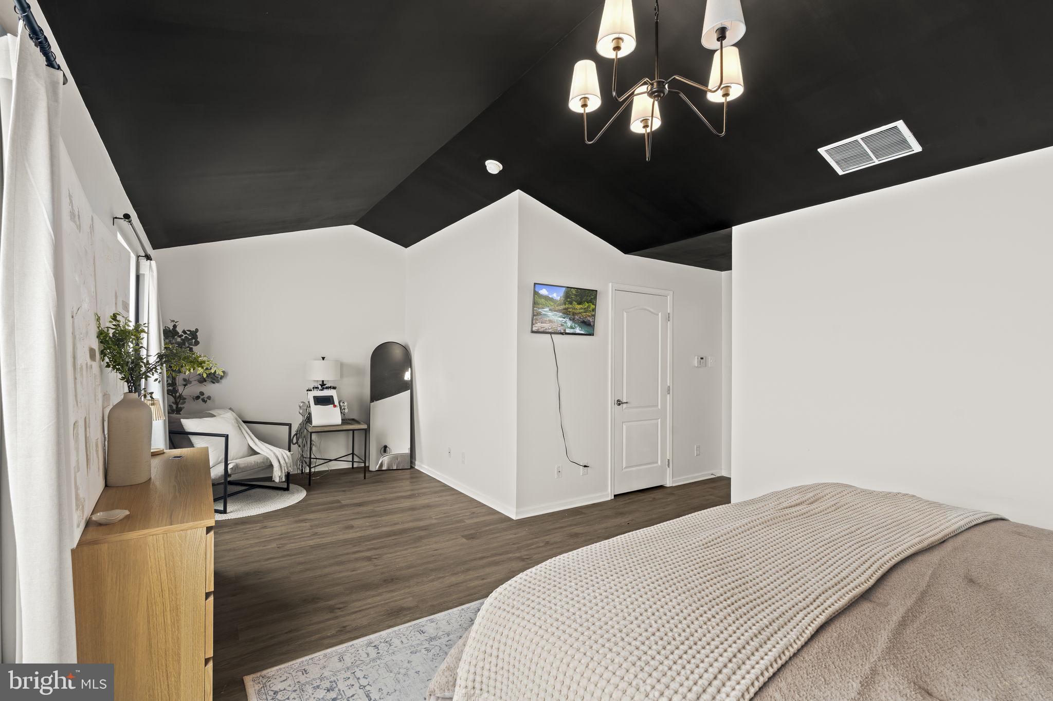 103 Oak Ridge Drive Mount Royal, NJ 08061 - Photo 24 of 34 a bedroom with a bed and a chandelier