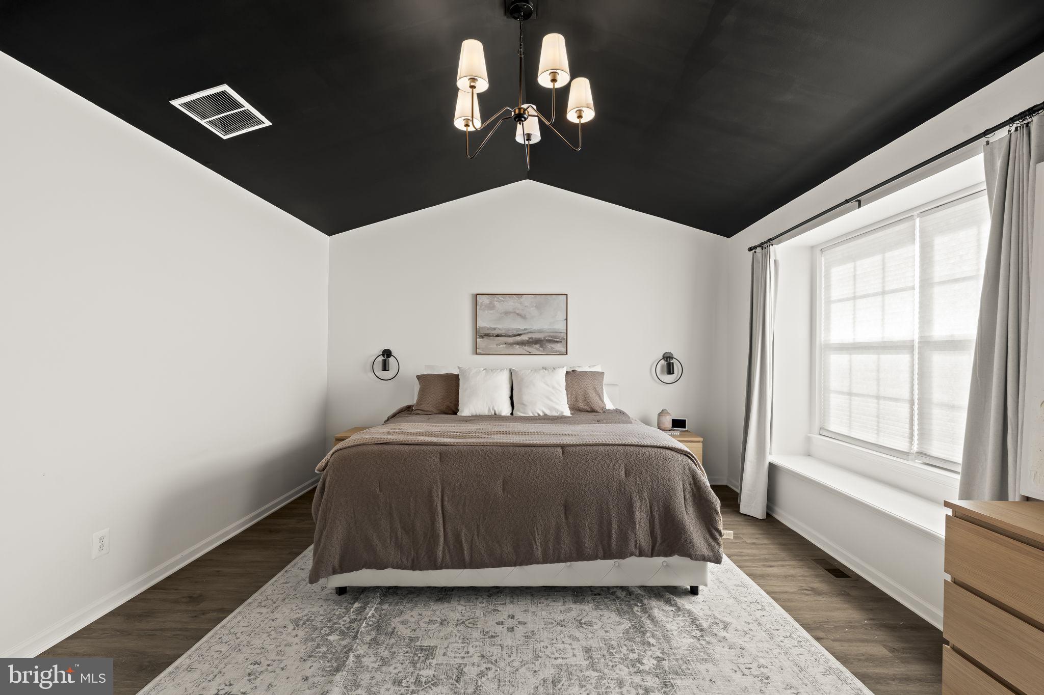 103 Oak Ridge Drive Mount Royal, NJ 08061 - Photo 25 of 34 a bedroom with a bed and a chandelier