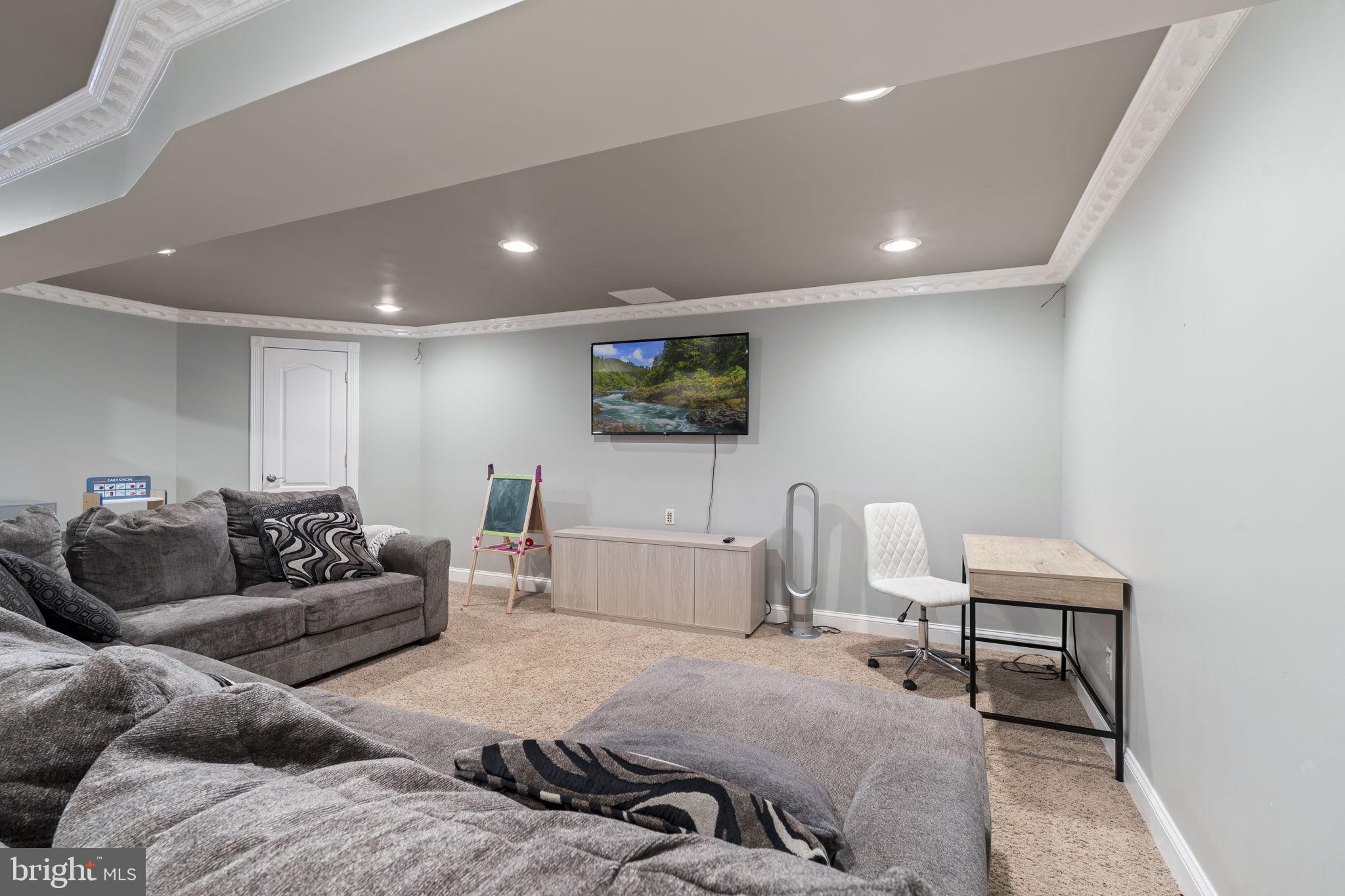 103 Oak Ridge Drive Mount Royal, NJ 08061 - Photo 30 of 34 a living room with furniture and a flat screen tv