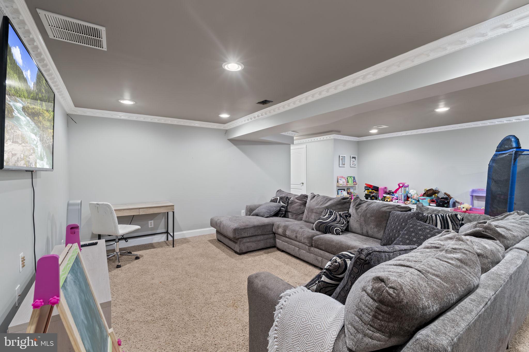 103 Oak Ridge Drive Mount Royal, NJ 08061 - Photo 31 of 34 a living room with furniture and a flat screen tv
