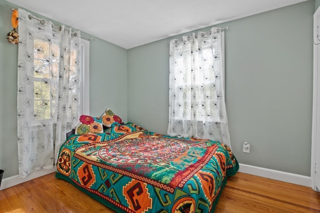 19 Manor Avenue Natick, MA 01760 - Photo 15 of 29 a bedroom with a bed and wooden floor