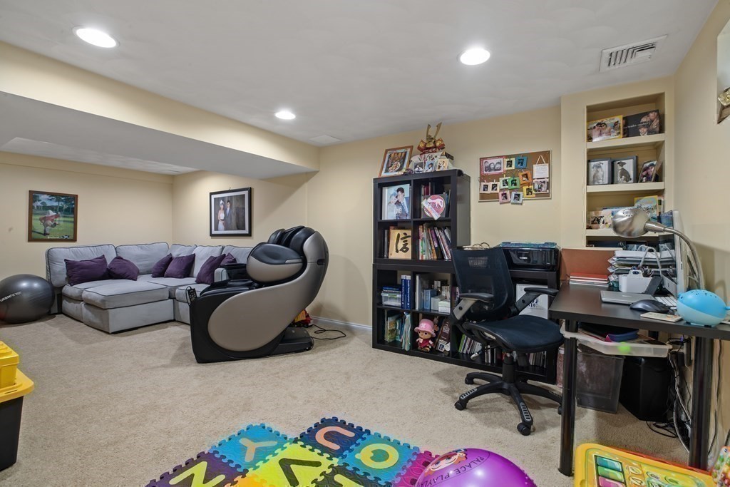 19 Manor Avenue Natick, MA 01760 - Photo 25 of 29 a living room with furniture a piano and a bookshelf