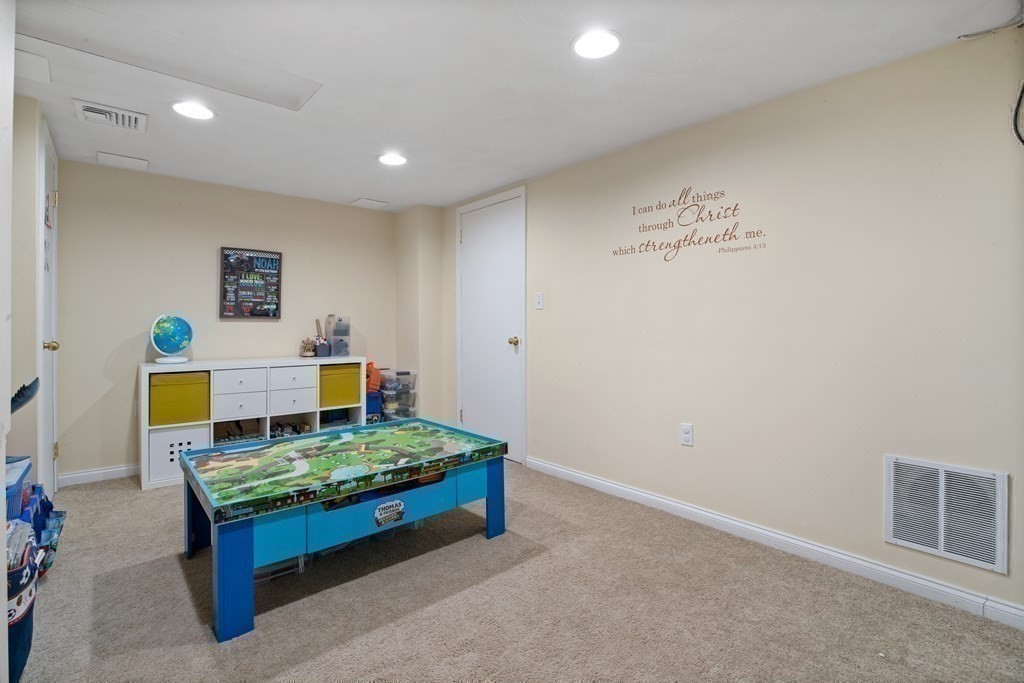 19 Manor Avenue Natick, MA 01760 - Photo 26 of 29 a bedroom with a bed and a table in it