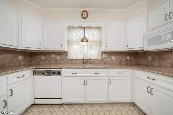 a kitchen with white cabinets and white appliances