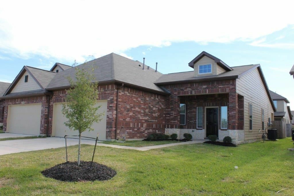 12434 Gemma Lane Houston, TX 77044 - Photo 1 of 15 a front view of a house with garden