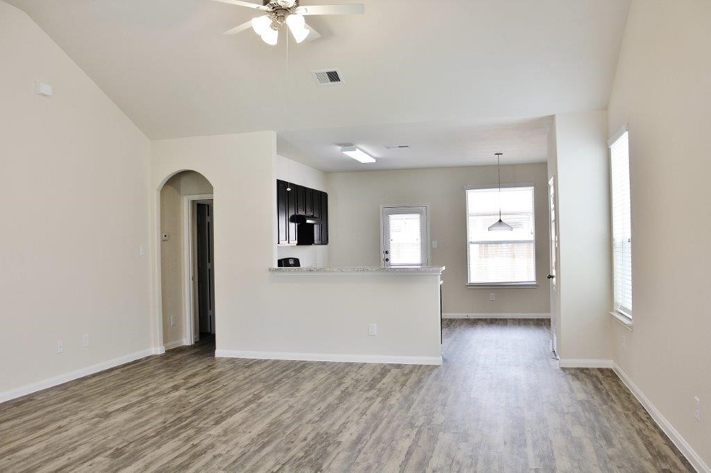 12434 Gemma Lane Houston, TX 77044 - Photo 11 of 15 a view of a big room with wooden floor and windows