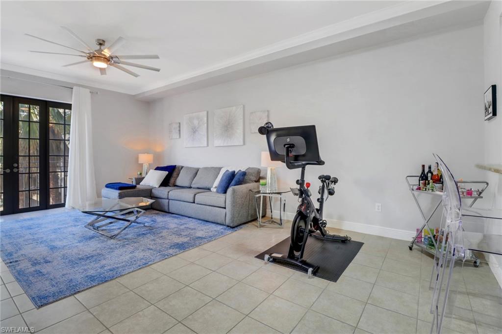 8011 Via Monte Carlo Way, Unit 2208 Estero, FL 33928 - Photo 11 of 34 a living room with furniture gym equipment and a window