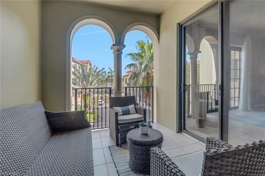 8011 Via Monte Carlo Way, Unit 2208 Estero, FL 33928 - Photo 15 of 34 a living room with furniture and a floor to ceiling window