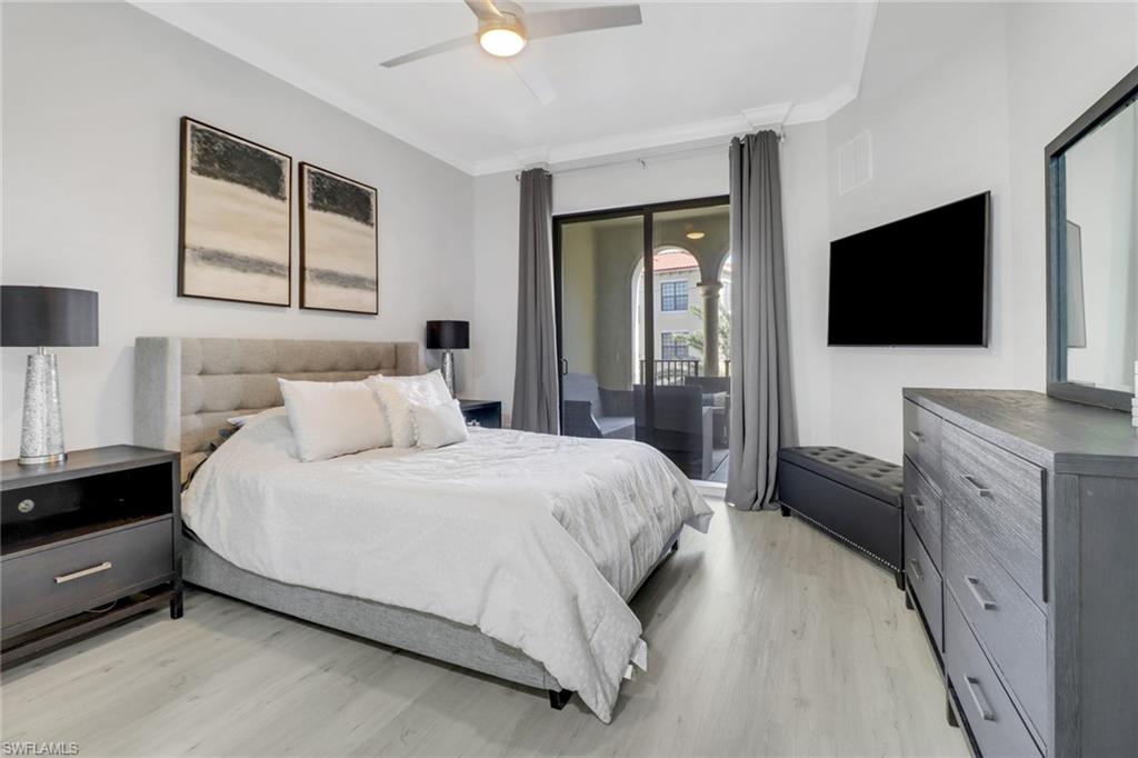 8011 Via Monte Carlo Way, Unit 2208 Estero, FL 33928 - Photo 17 of 34 a bedroom with a bed and a flat tv screen on wall